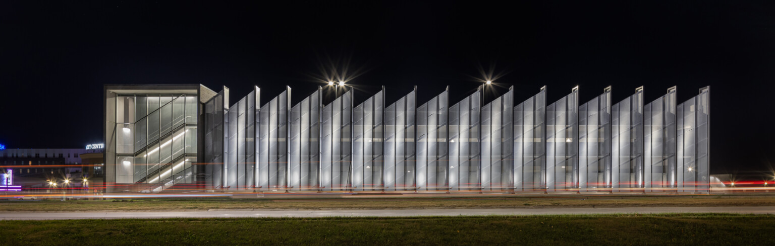 serrated edge translucent walled parking garage in la vista city centre