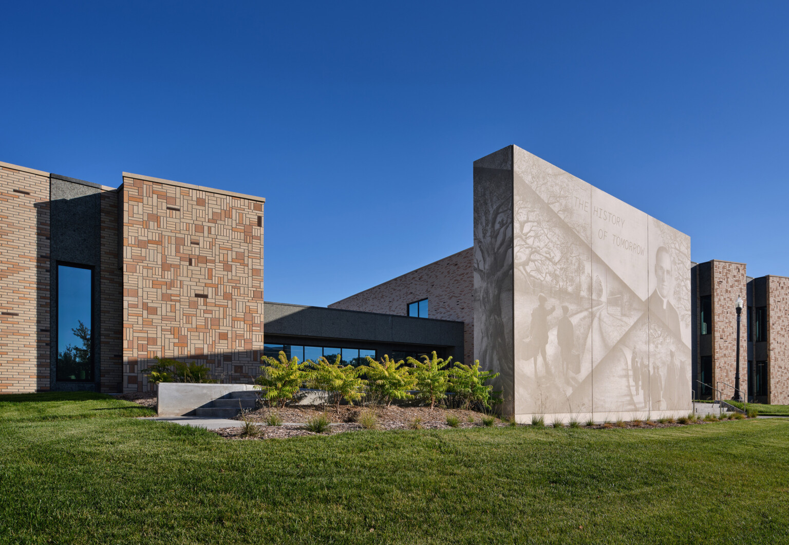 Stone building with a mural light with phrase the history of tomorrow