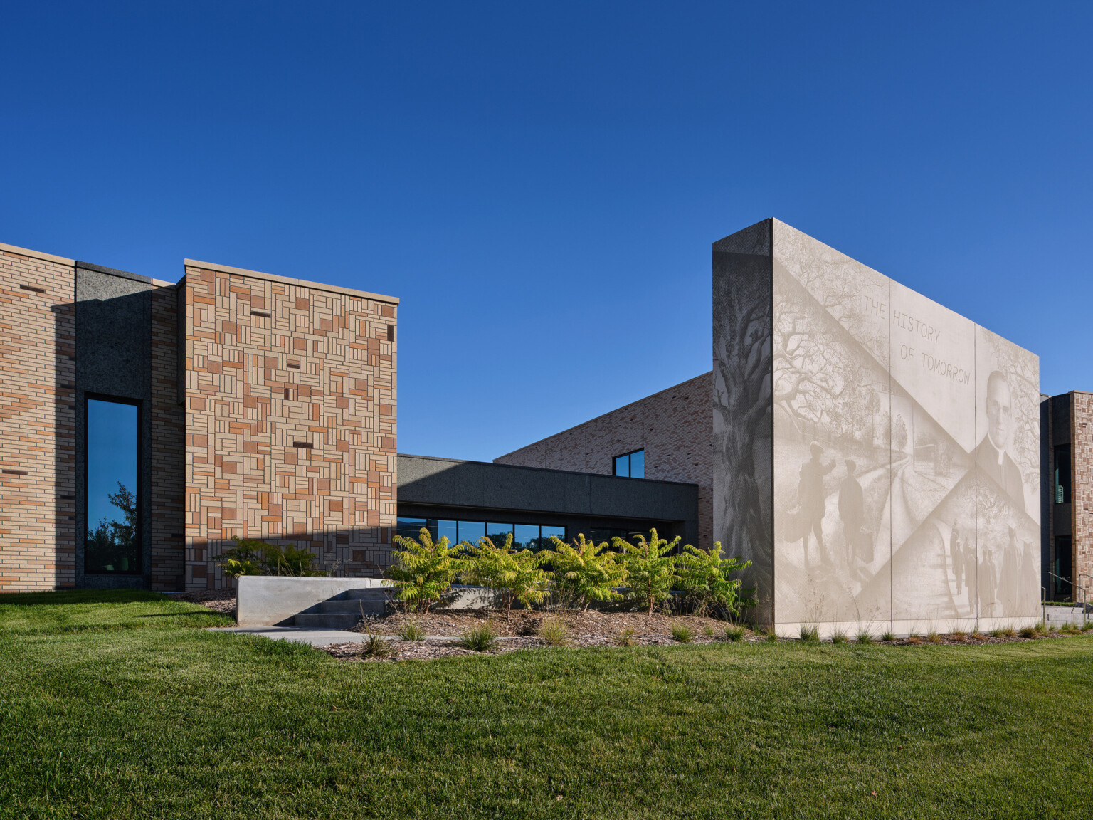 Stone building with a mural light with phrase the history of tomorrow