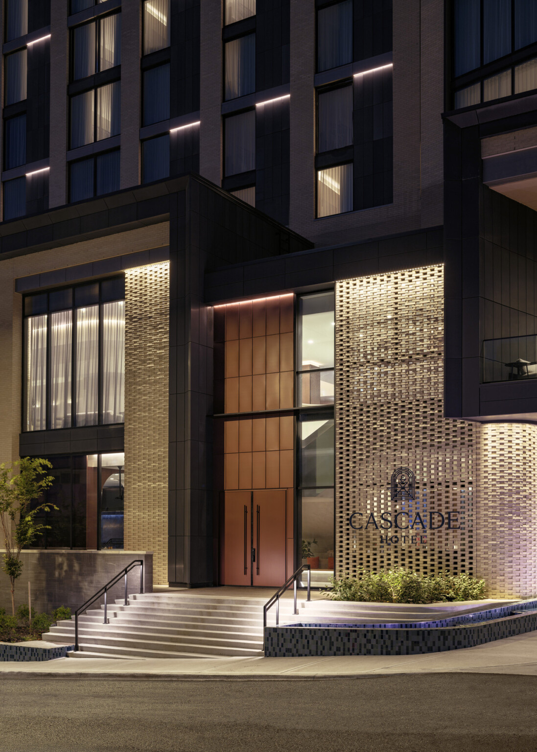 Large wooden accent hotel entry showing modern brick work with Cascade Hotel sign