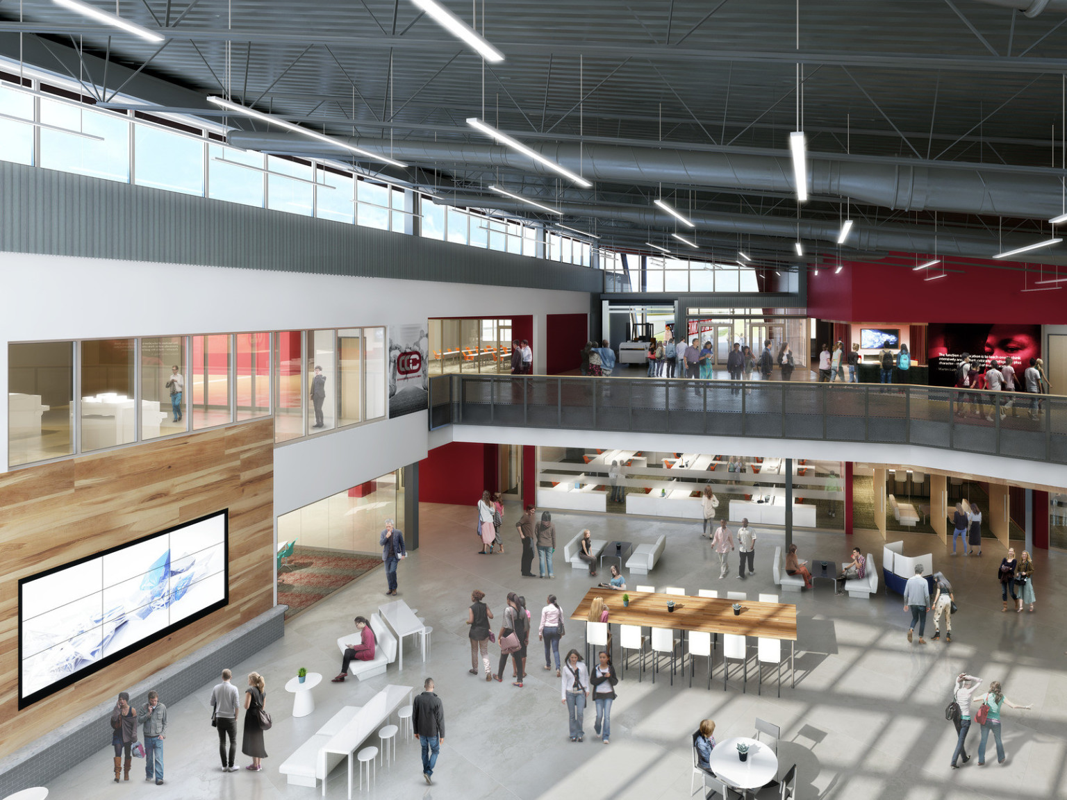 Double height atrium with learning stairs, right, to 2nd floor hallway and classrooms. Mixed seating below with wood accents