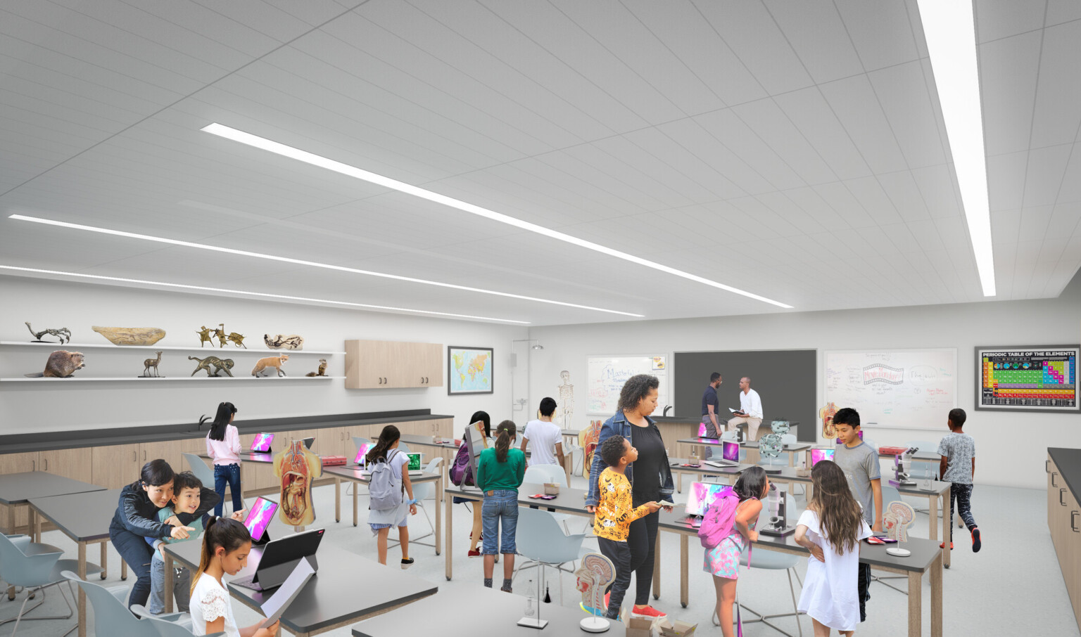 interactive museum room with facilitator and children at work tables with web tablets, white room with overhead tube lighting