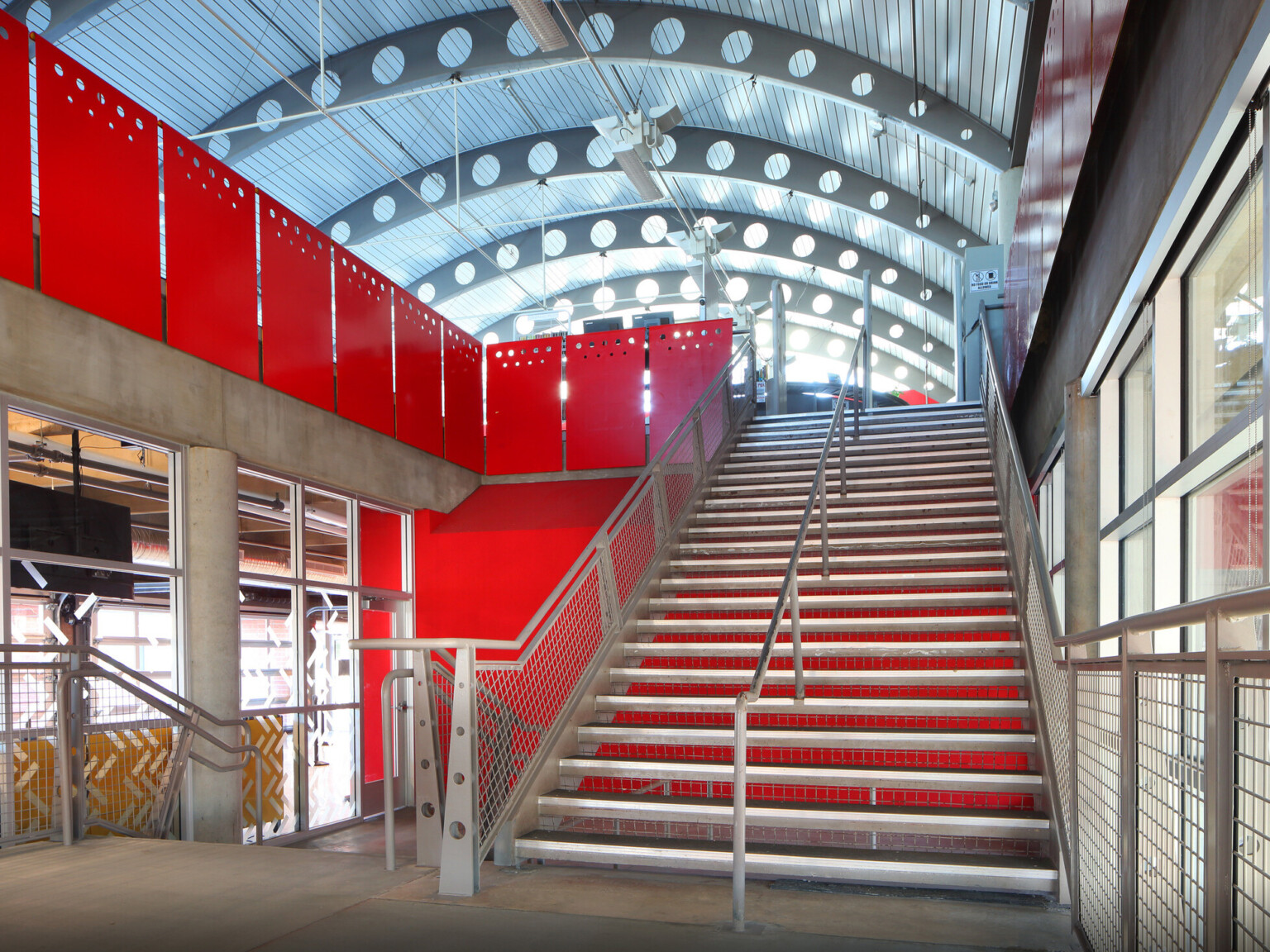 interior staircase, bright red partitions, barrel ceiling with glass and steel