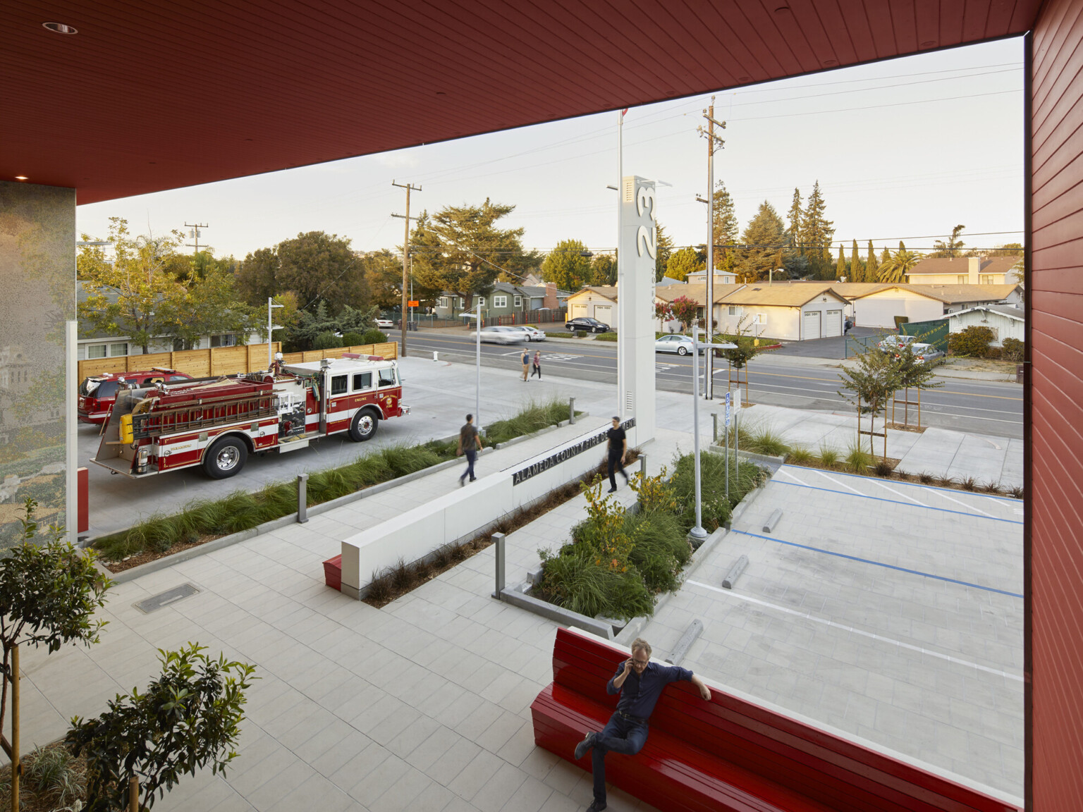 Fire station from the second story looking at the front entry with emergency vehicles in the drive.