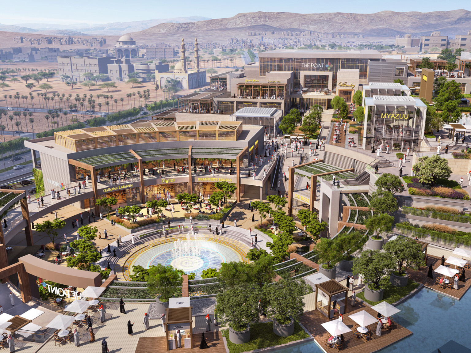 Aerial view of the campus plan built into a hill with rounded central courtyard lined with canopies, midrise buildings to left