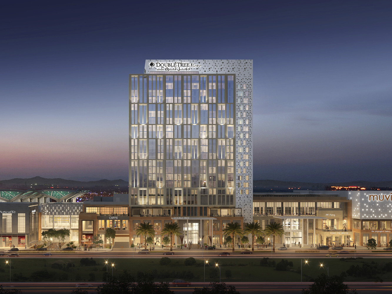 3 story building seen from across parking lot, Double Tree hotel rising above at center. Multiple entrances and large windows