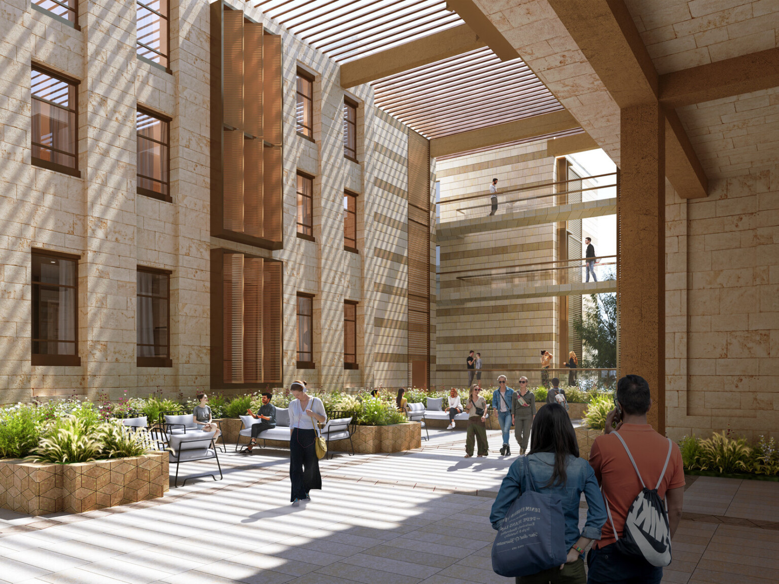 An interior courtyard of a university building. The space is open to the sky and features a mix of stone and wooden architectural elements, with sunlight streaming through slatted overhead structures, creating intricate patterns of light and shadow on the ground