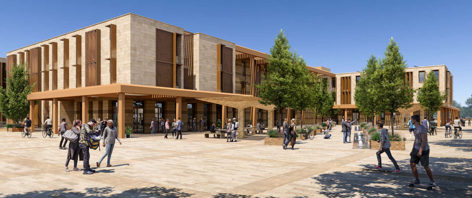 An exterior render of a modern university campus building with large windows and wooden accents. In front of the building is a spacious plaza with neatly paved walkways and several trees providing shade