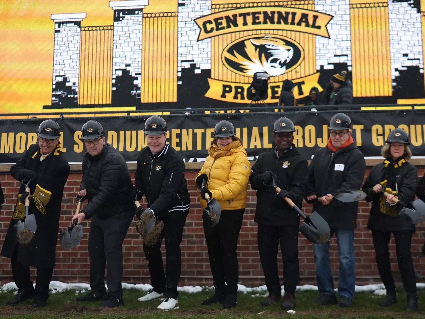 Groundbreaking at the University of Missouri Memorial Stadium Centennial Project showing people in a line with shovels